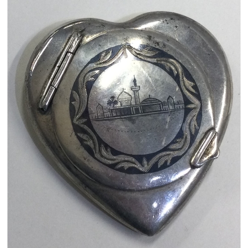 642 - A heart shaped Persian silver and Niello compact engraved with temples and camels. Approx. 59 grams.... 