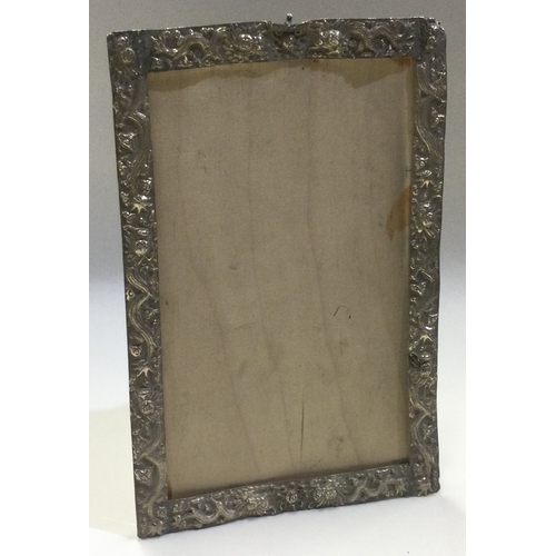 646 - A large Chinese silver picture frame embossed with dragons. Approx. 136 grams of gross weight. Est. ... 