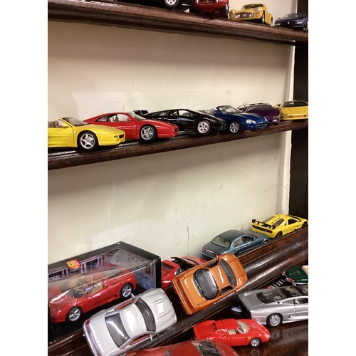 145 - A good collection of 1:18 scale model cars. Est. £20 - £30.