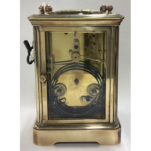 170 - A large brass carriage clock with white enamelled dial. Est. £50 - £80.