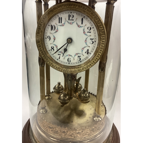 173 - A large brass mounted mantle clock with white enamelled dial. Est. £60 - £80.