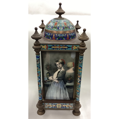 174 - A large Continental brass and enamelled clock decorated in bright colours. Est. £50 - £80.