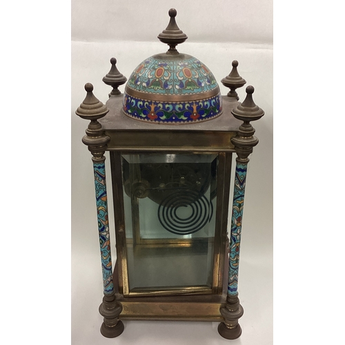 174 - A large Continental brass and enamelled clock decorated in bright colours. Est. £50 - £80.