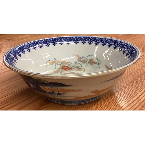 217 - A large Chinese bowl decorated with buildings. Signed to base. Est. £30 - £50.