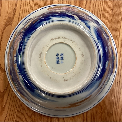 217 - A large Chinese bowl decorated with buildings. Signed to base. Est. £30 - £50.