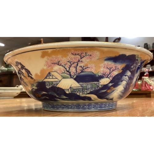 217 - A large Chinese bowl decorated with buildings. Signed to base. Est. £30 - £50.