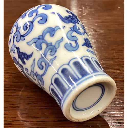 226 - A good Chinese miniature blue and white baluster shaped vase with flora decoration. Est. £50 - £80.