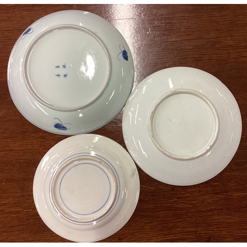 228 - A group of three Chinese blue and white dishes of typical form. Est. £20 - £30.