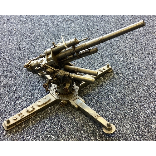 277 - A heavy cast metal model of a machine gun on stand. Est. £20 - £30.