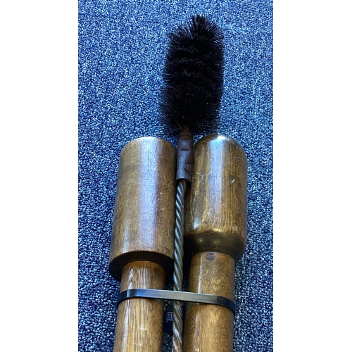 303 - A set of loading rams together with a cleaning brush. Est. £20 - £30.