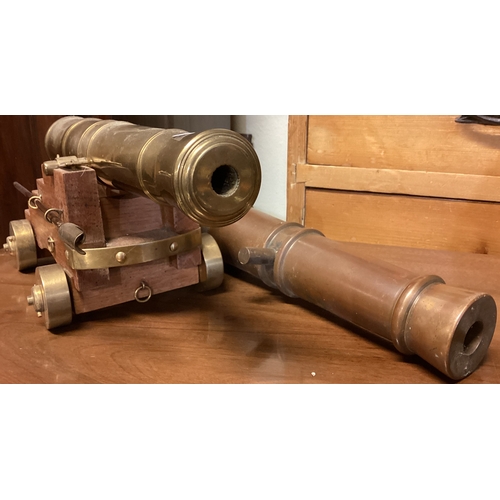 315 - A large oak and brass model of a cannon etc. Est. £20 - £30.