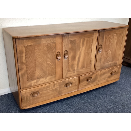 431 - ERCOL: A three-door sideboard. Est. £50 - £80.