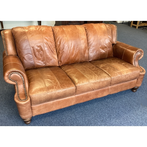 454 - A good leather button back sofa. Est. £100 - £150.