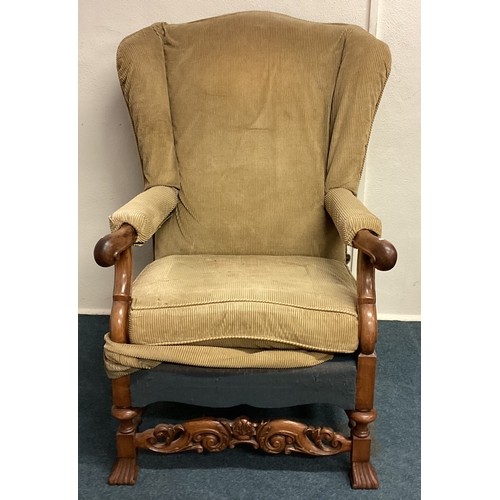 467 - A large Continental wingback chair. Est. £60 - £80.