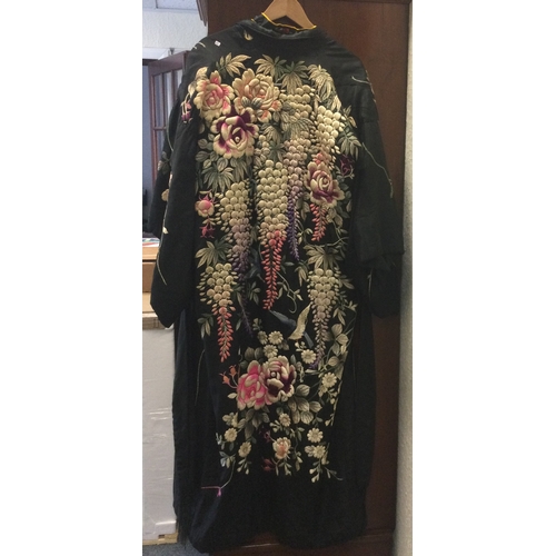 542 - An old silk dressing gown together with another example. Est. £10 - £20.