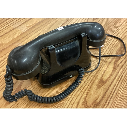 90 - An old Bakelite black telephone. Est. £20 - £30.