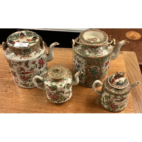 204 - Two large Chinese teapots together with two smaller examples. Est. £20 - £30.