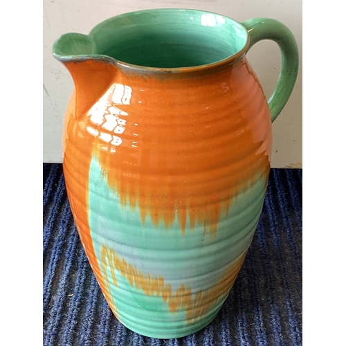 553 - SHELLEY: A large green and orange glazed pottery jug. Approx. 25.5 cms high. Est. £20 - £30.