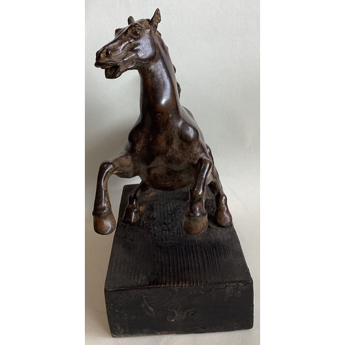 429 - A bronze figure of a rearing horse mounted on wood plinth. Approx. 24 cms high. (Base approx. 27.5 c... 