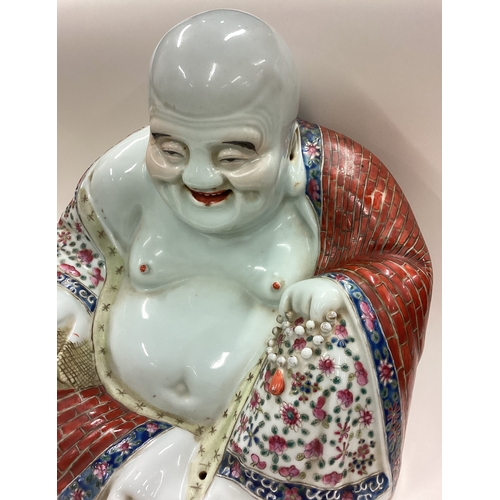 191 - A large Chinese figure of a Buddha on hardwood stand. Est. £50 - £80.