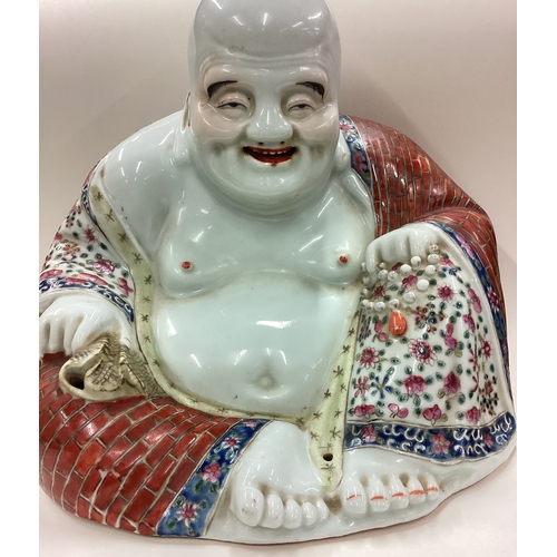 191 - A large Chinese figure of a Buddha on hardwood stand. Est. £50 - £80.