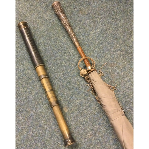 604 - An Indian silver umbrella together with a good brass telescope. Est. £60 - £80.