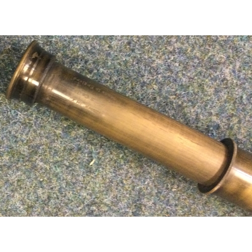 604 - An Indian silver umbrella together with a good brass telescope. Est. £60 - £80.