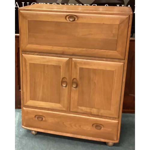 482 - ERCOL: A good drop flap cupboard with single drawer. Est. £50 - £80.