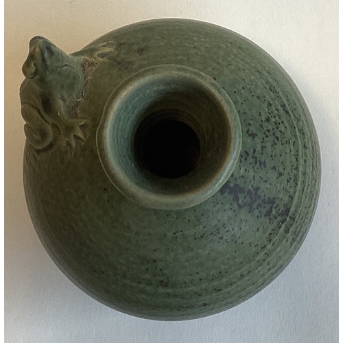 581 - A small celadon stoneware bud vase with tree frog to side. Approx. 13 cms high. Marked 'H' to base. ... 