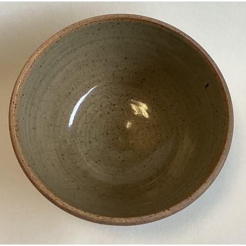 584 - A small stoneware pottery bowl with green glaze to interior. Impressed mark to base. Approx. 13 cms ... 