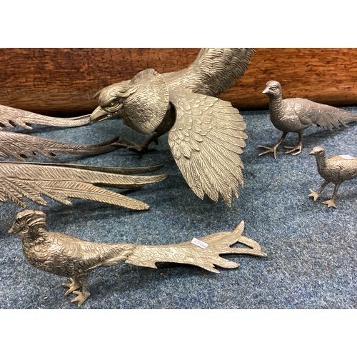 594 - A collection of seven metal birds. Est. £20 - £30.