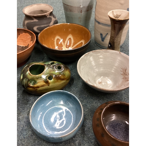 580 - A selection of 11 various studio pottery items. Est. £40 - £60.