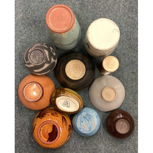 580 - A selection of 11 various studio pottery items. Est. £40 - £60.