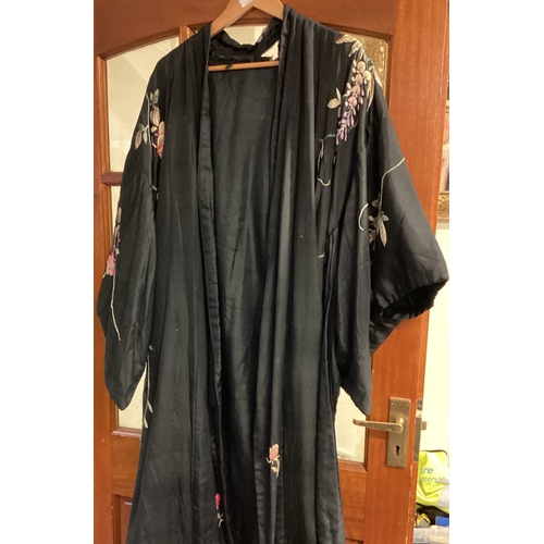 542 - An old silk dressing gown together with another example. Est. £10 - £20.