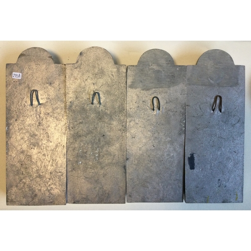 275A - A set of four aluminium wall plaques depicting knights. Est. £30 - £40.