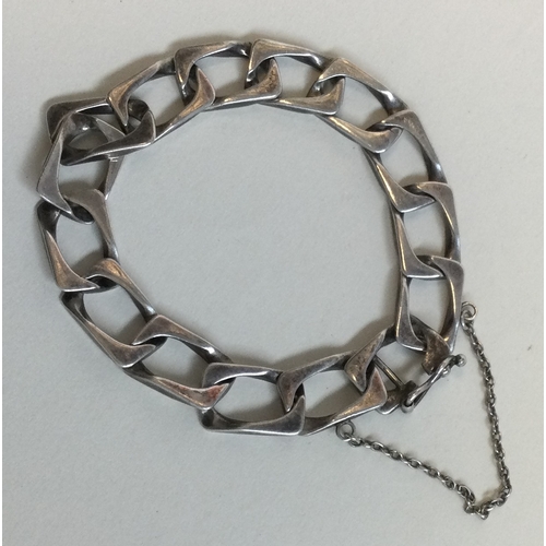 209A - A silver curb link bracelet together with a silver horseshoe brooch with charms. Est. £20 -£30.