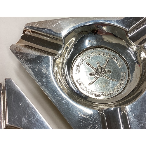 11 - A rare pair of Persian silver ashtrays / dishes inset with coins. Approx. 96 grams. Est. £80 - £120.