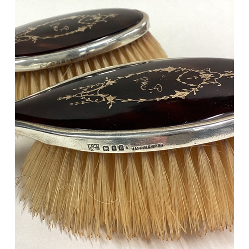 136 - A pair of silver mounted and tortoiseshell brushes. London 1908. By Mappin & Webb. Est. £50 - £80.