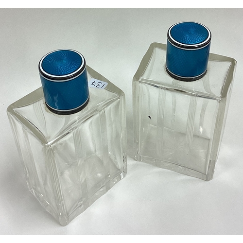 137 - A pair of French silver and blue enamelled scent bottles. Marked inside. Circa 1920. Est. £100 - £15... 