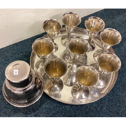 140 - A large silver plated cocktail shaker together with goblets on tray. Est. £30 - £50.