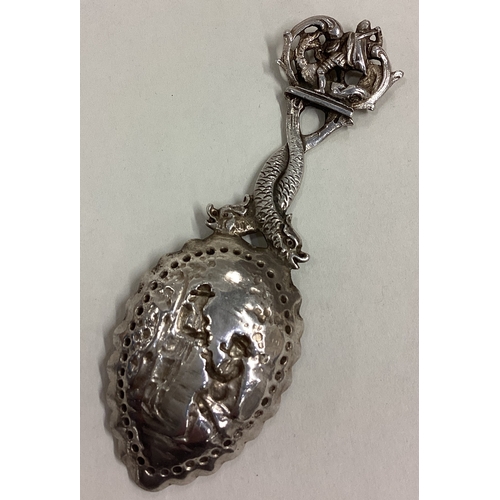 142 - A good quality Continental silver caddy spoon with scroll decoration. Approx. 27 grams. Est. £30 - £... 