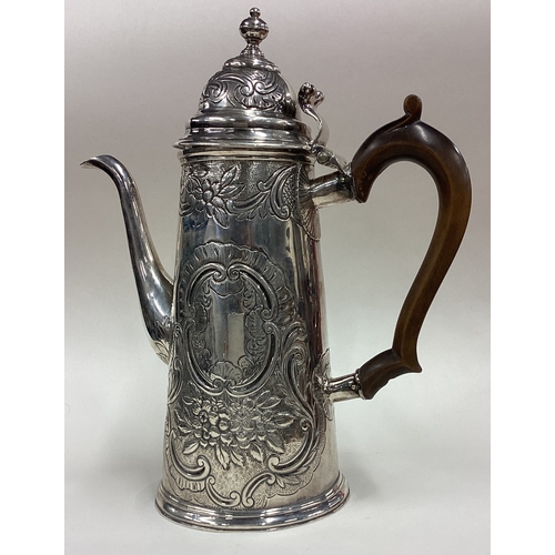 15 - A large 18th Century silver coffee pot with chased decoration. Circa 1720. Approx. 524 grams. Est. £... 