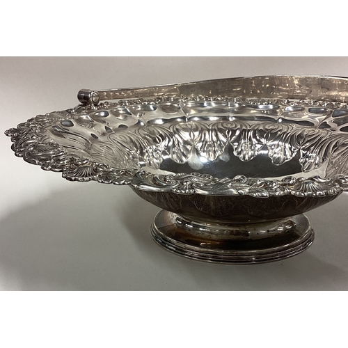 16 - A large Georgian silver basket with shell border and chased decoration to interior and handle. Sheff... 