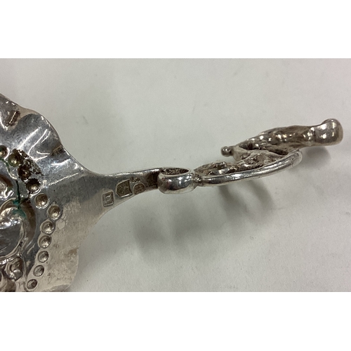 163 - A Dutch silver caddy spoon with chased decoration. Approx. 26 grams. Est. £40 - £60.