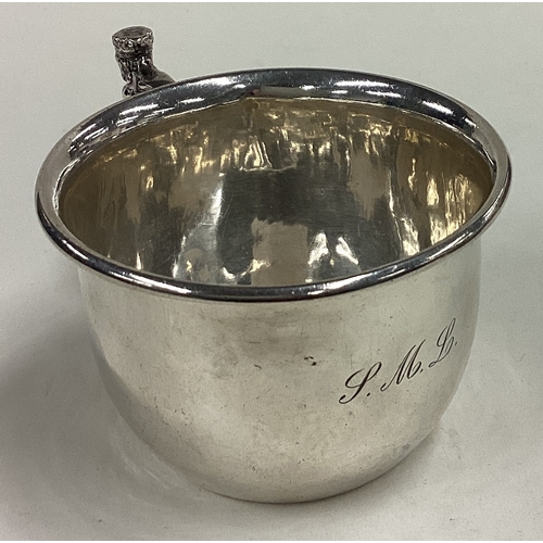 167 - A E JONES: A silver mug with figural handle. Birmingham 1936. Approx. 99 grams. Est. £80 - £120.