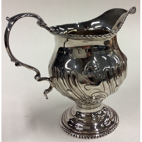 169 - A heavy George III silver fluted cream jug. London 1761. Approx. 127 grams. Est. £100 - £150.