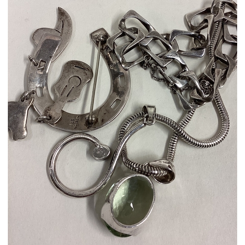 19 - A heavy silver flat link bracelet, pendant and brooch. Approx. 80 grams. Est. £20 - £30.