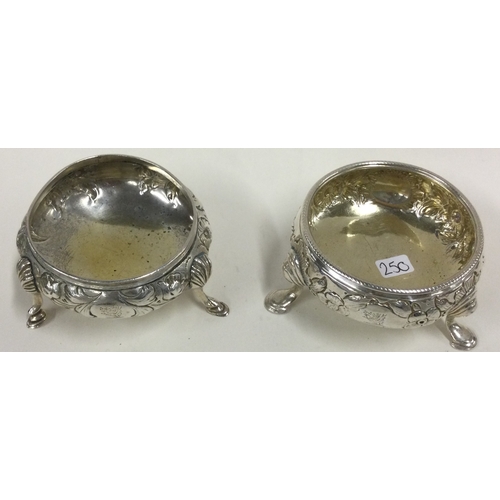 250 - A matched pair of chased silver salt cellars embossed with floral decoration. Approx. 109 grams. Est... 