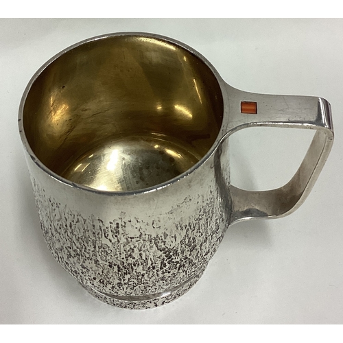 288 - An unusual hammered silver mug with stone decoration to handle. London 1984. By PGW. Approx. 329 gra... 