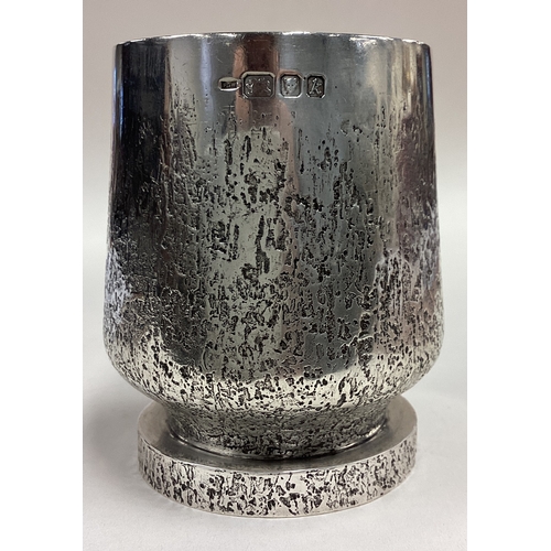 288 - An unusual hammered silver mug with stone decoration to handle. London 1984. By PGW. Approx. 329 gra... 